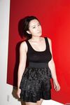 Skinny Chinese babe Li Zheng poses in the black T-shirt and skirt